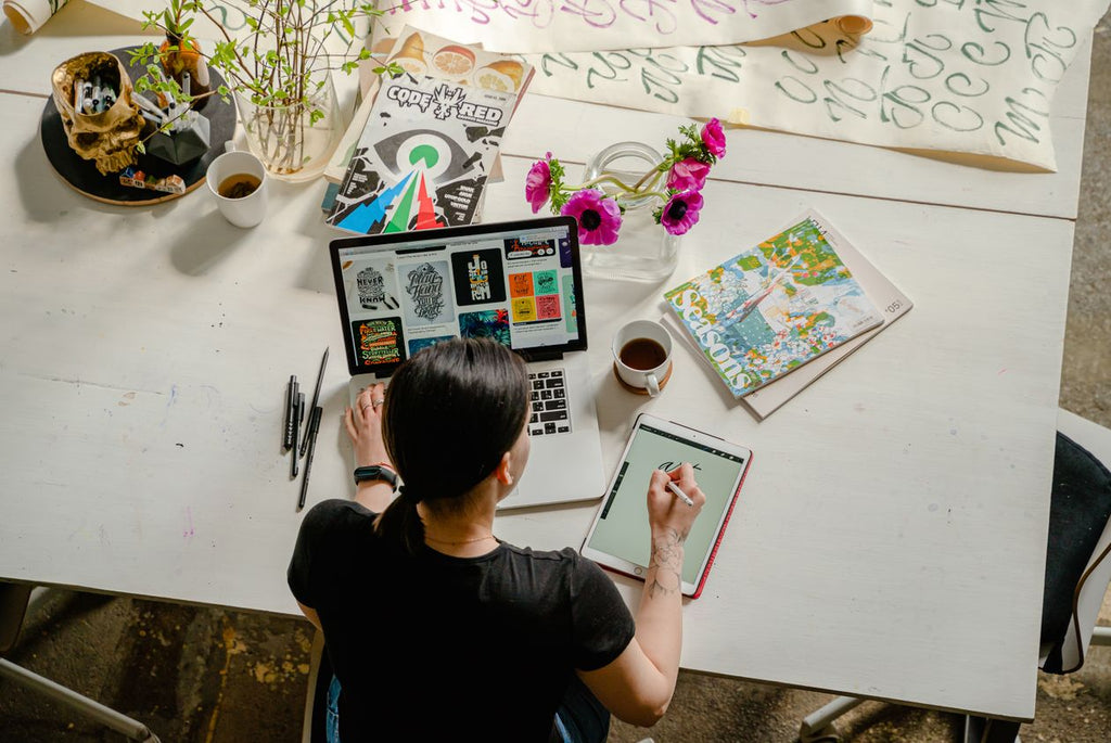 Woman organizing life with planner and journal spread