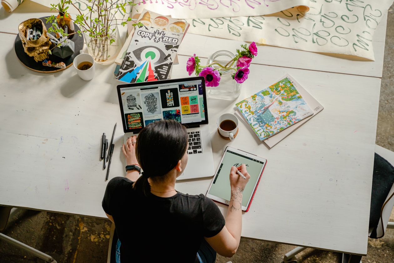 Woman organizing life with planner and journal spread
